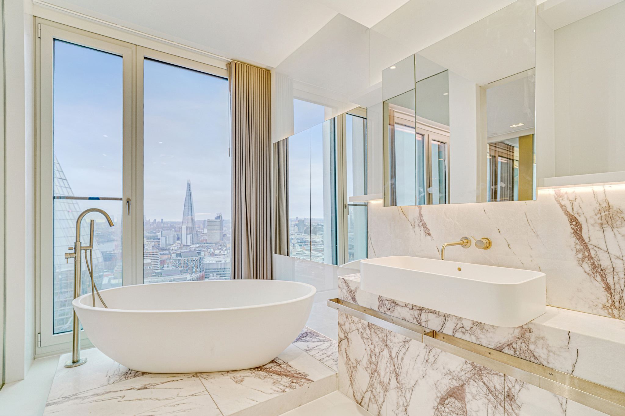 luxury-bathroom-property-photography-london-shard-view Luxury bathroom with freestanding bathtub and floor-to-ceiling windows photographed for a premium residential property in London.