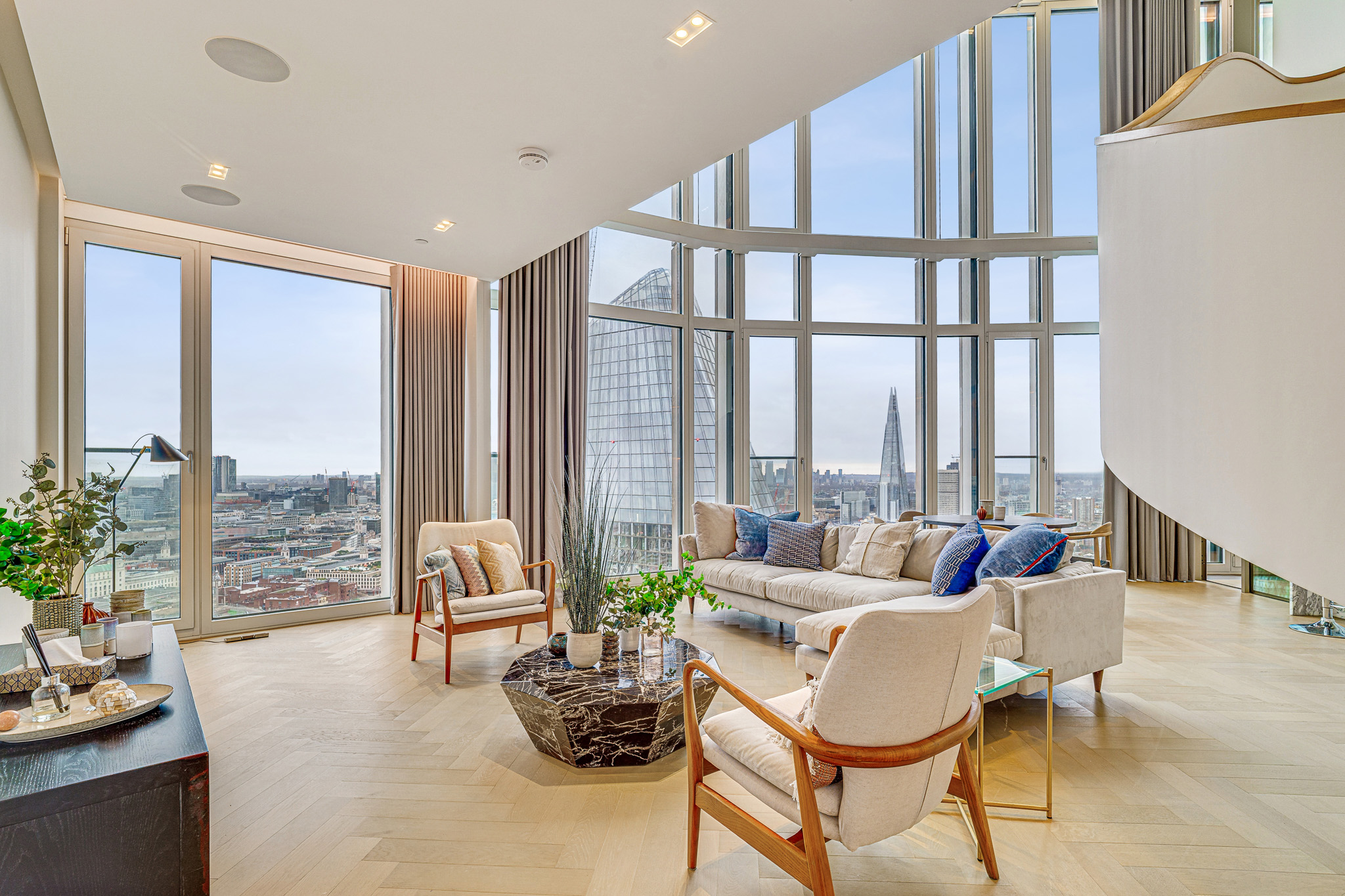 Luxury Living Room | Property Photography London Luxury open-plan living room with floor-to-ceiling windows and panoramic London skyline views, professionally photographed for a premium residential property.